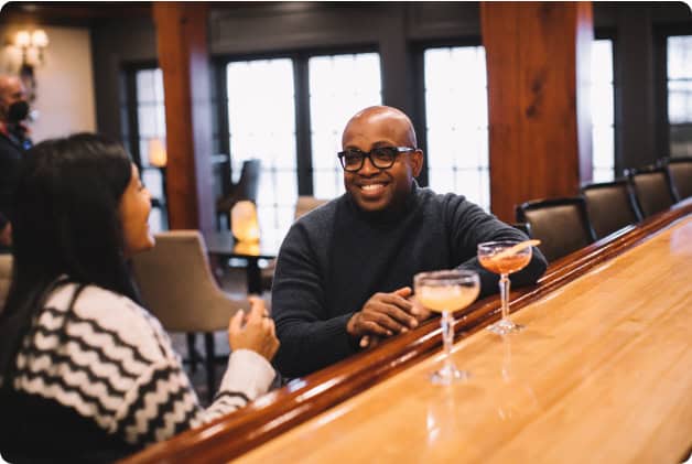 Two Guests Chatting Over Cocktails at Our New York Lake Resort