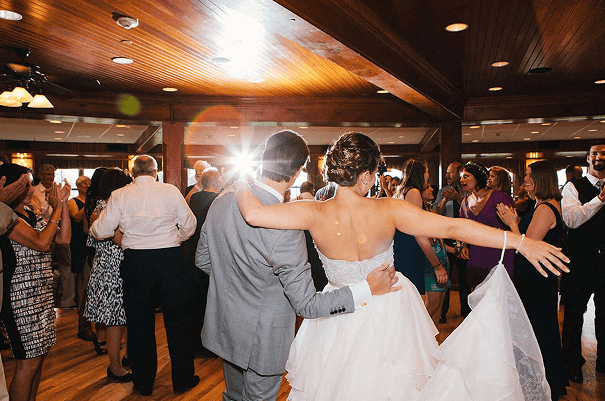 A festive wedding reception with guests dancing